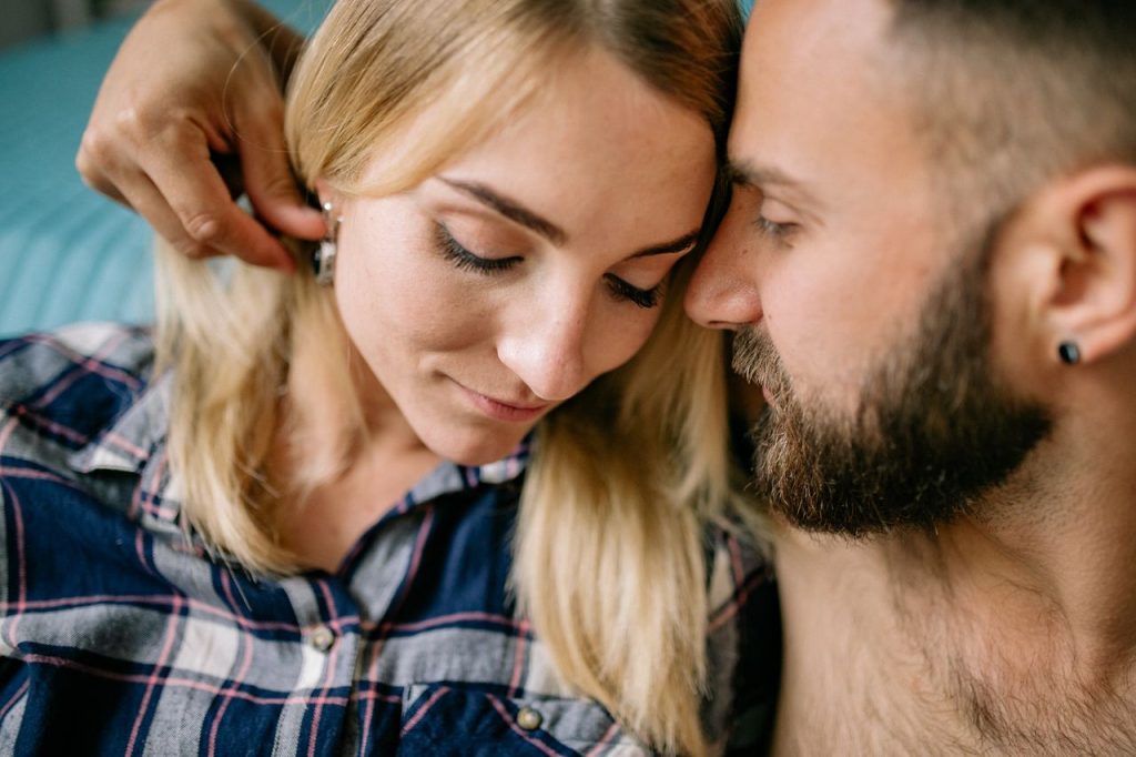 Close-up of a loving couple embracing with warmth and affection. Perfect for depicting romance.